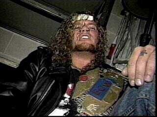 Raven cuts a dingy promo with the ECW World title on his shoulder as he talks to the camera.